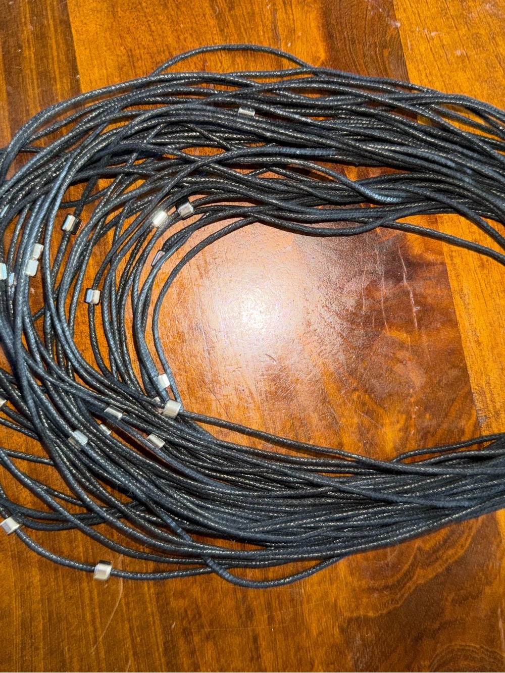 Multi-Strand Black Cord Necklace with Silver Accent Beads. Magnetic close.